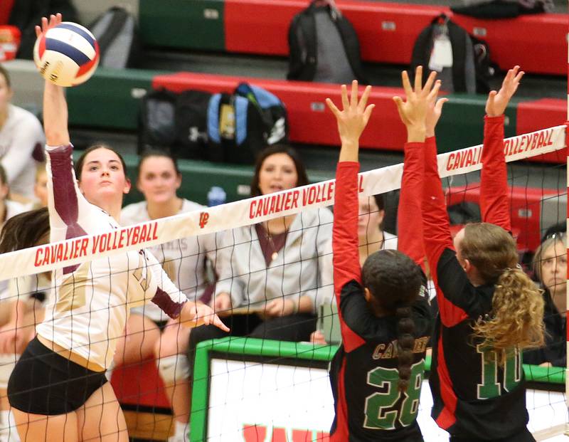 Morris's Emma Leavitt sends a spike past L-P's Ava Currie and Katie Sowers in the Class 3A Regional game on Thursday, Oct. 26, 2023 at Sellett Gymnasium.