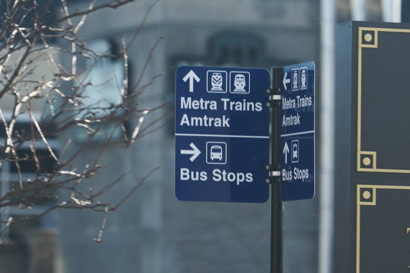 A Metra sign provides directions at the intersection of Jefferson Street and Scott Street in Joliet.