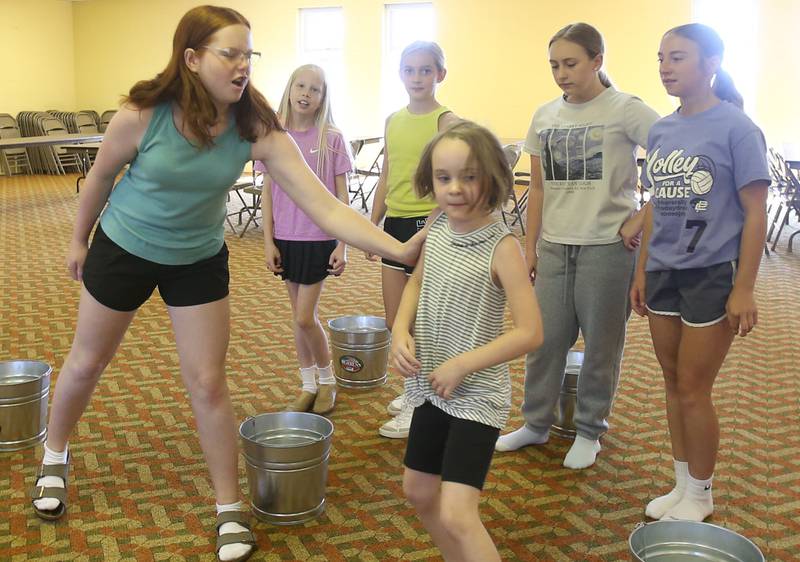 (From left) Ruby Stash, Sutter Dever, Sophia Smith, Noelle Briggs, Gwynevere Maddex and Trinity Frawley rehearse a scene for the upcoming musical Annie Jr. on Tuesday, June 24, 2025 at the First United Methodist Church in Henry. The show will be presented July 25-27 at the River Valley Players theater in Henry, .
