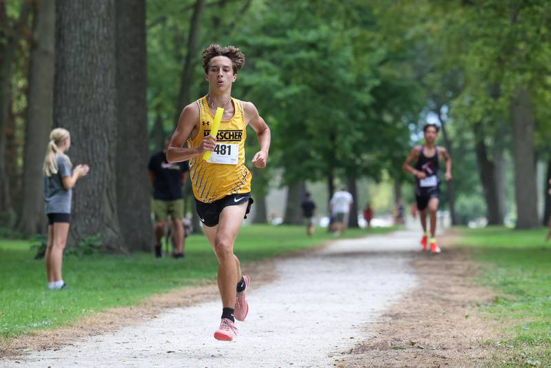 Herscher's Jackson Kruse runs the second leg of the race during the Irish Conditioner at Small Memorial Park in Kankakee on Wednesday, Sept. 3, 2025.