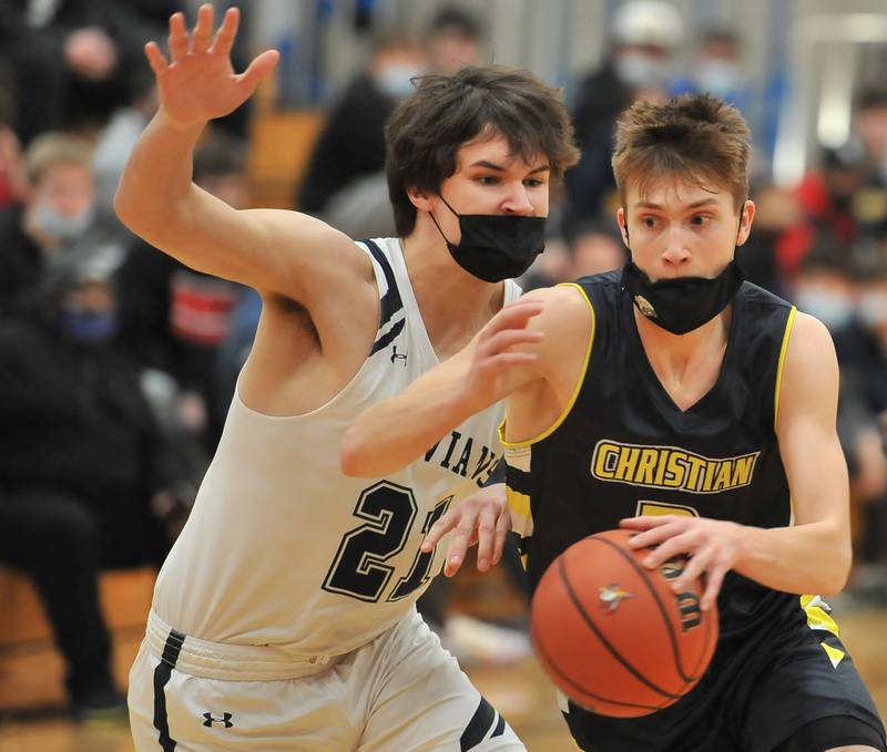 Yorkville Christian's Jaden Schutt (right) drives past New Trier's Finn Cohan during a game on Jan. 22, 2022 at Benet Academy in Lisle.