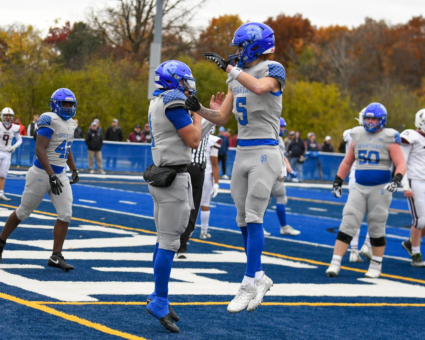 St. Francis's Brock Phillip, left, celebrates his touchdown with teammate St.  Zach Washington (5) on Saturday Nov. 8, 2025, during the second round of the 5A playoff game while taking on Prairie Ridge held at St. Francis's High School.