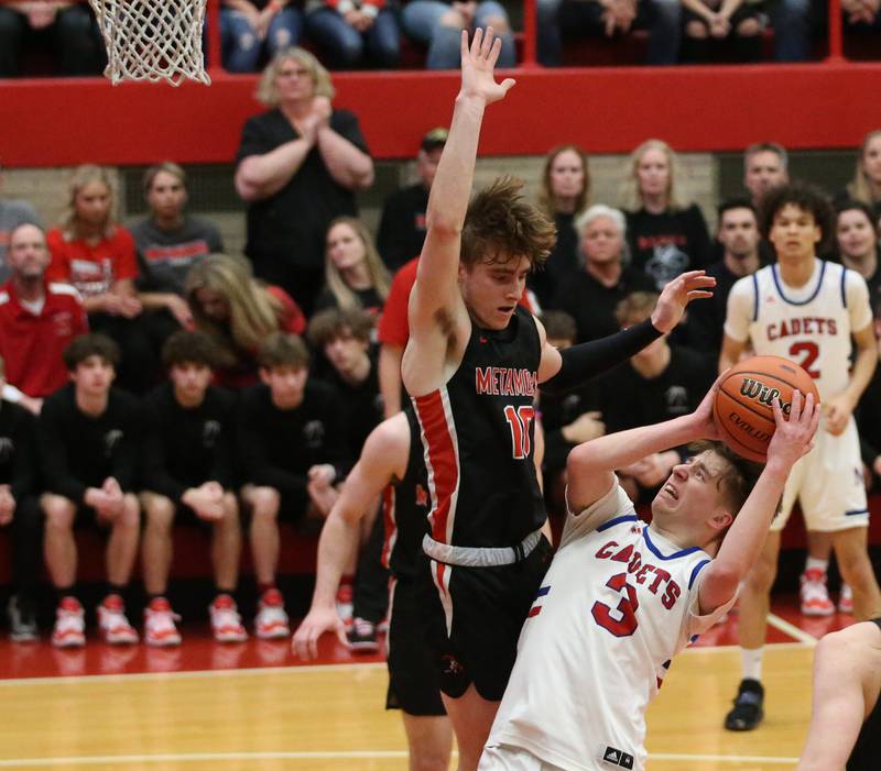 Marmion's Collin Wainscott pulls up in the lane as Metamora's Tyler Mason defends during the Class 3A Super-Sectional on Monday, March 6, 2023 at Ottawa High School.