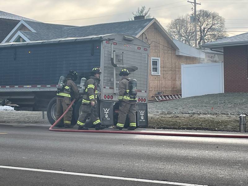 Spring Valley firefighters douse the rear axel of a semi carrying soybeans Monday morning in the 200 block of West Dakota Street. The axel fire likely was caused by a brake or tire failure.