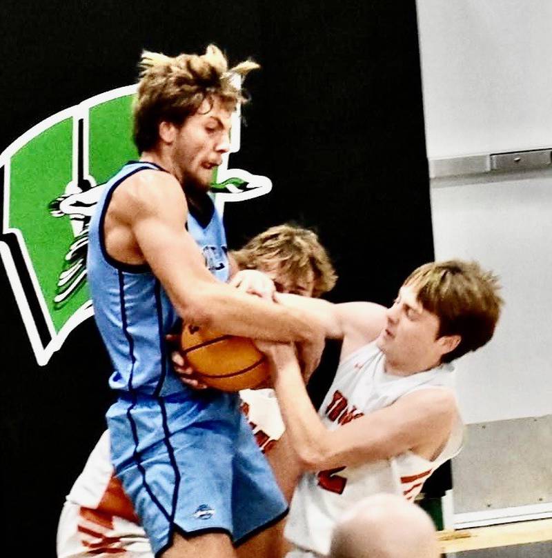 Bureau Valley's Landon Hulsing (left) battles for a rebound against Elmwood in Saturday's finals of the Wally Keller Invite at Wethersfield. The Storm beat the Trojans 50-37 to claim second place, finishing 4-1.
