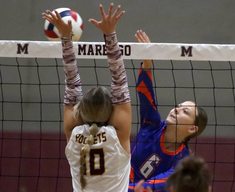 Genoa-Kingston’s Addison Vicary, right, hits the ball as Richmond-Burton’s Daniella Mazzola blocks in IHSA Class 2A Regional Title Game volleyball action on Thursday, Oct. 31, 2024, at  Marengo High School  in Marengo.