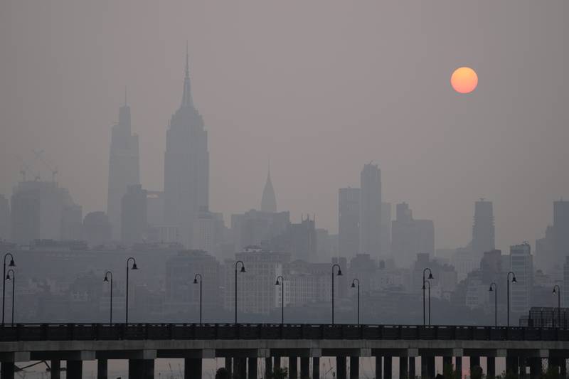 The sun rises over a hazy New York City skyline as seen from Jersey City, N.J., Wednesday, June 7, 2023. Intense Canadian wildfires are blanketing the northeastern U.S. in a dystopian haze, turning the air acrid, the sky yellowish gray and prompting warnings for vulnerable populations to stay inside. (AP Photo/Seth Wenig)