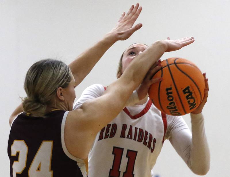 Huntley's Anna Campanelli is fouled by Loyola Academy's Grace Bronski as she drives to the basket during the IHSA Class 4A Gurnee Warren Supersectional girls basketball game on Monday, March 3, 2025, at Warren Township High School in Gurnee.