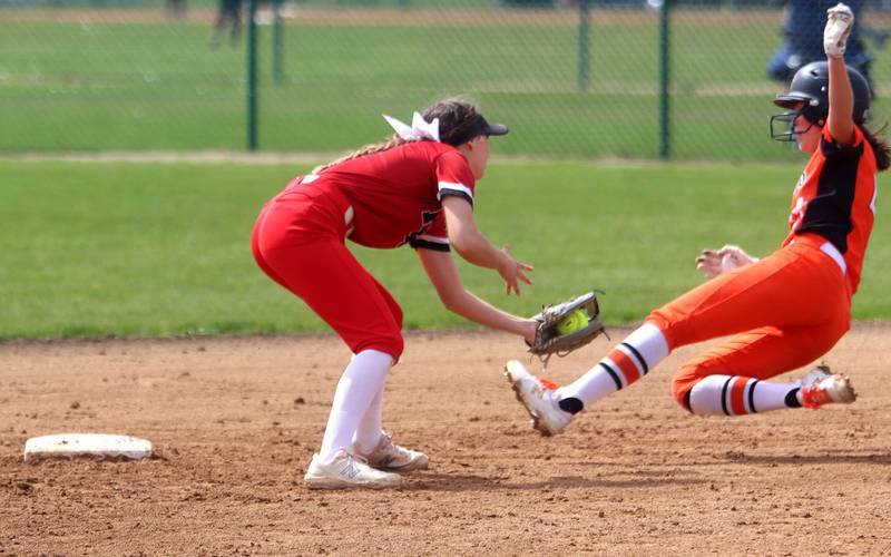 St. Charles East’s Stephanie Schnite, right, is caught stealing as Huntley’s Reese Hunkins prepares to apply a tag at second base during varsity softball at Marengo Saturday morning.