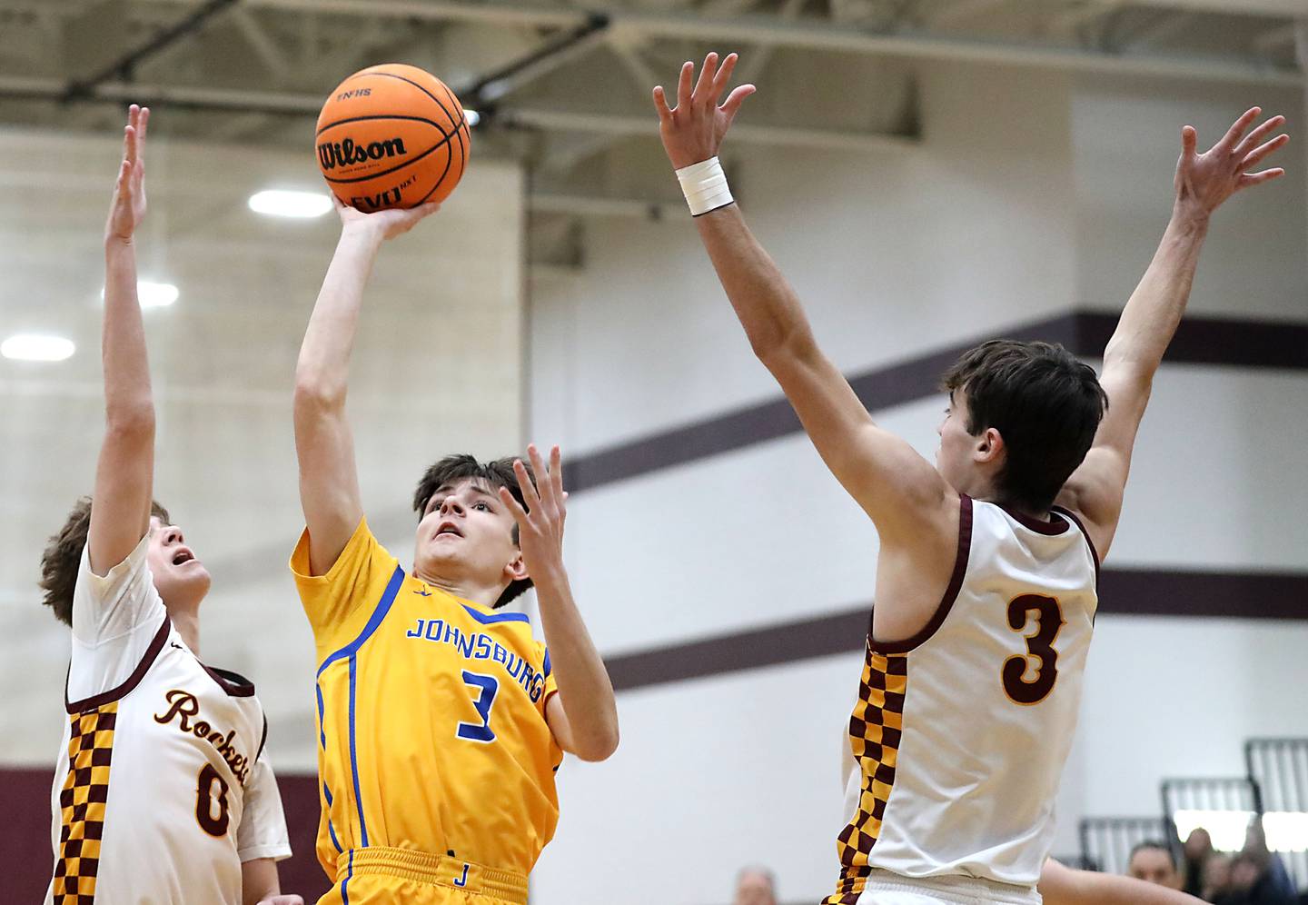 Johnsburg's Trey Toussaint (center) drives to the basket between Richmond-Burton's Gavin Radmer (left) and Dane Gardner (right) during a Kishwaukee River Conference boys basketball game on Tuesday, Jan. 27, 2026, at Richmond-Burton High School.