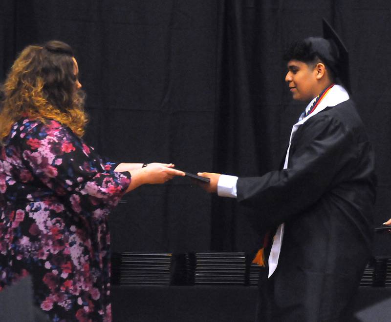 David Alexander Aquino Mendoza receives his diploma Sunday, May 22, 2022, during the Harvard High School Commencement Ceremony in Harvard .
