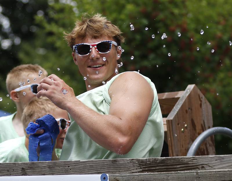 Teddy Burseth has water sprayed at him from the crowd as he rides on a Crystal Lake Park District float on Sunday, July 6, 2024, during Crystal Lake’s annual Independence Day Parade on Dole Avenue in Crystal Lake.