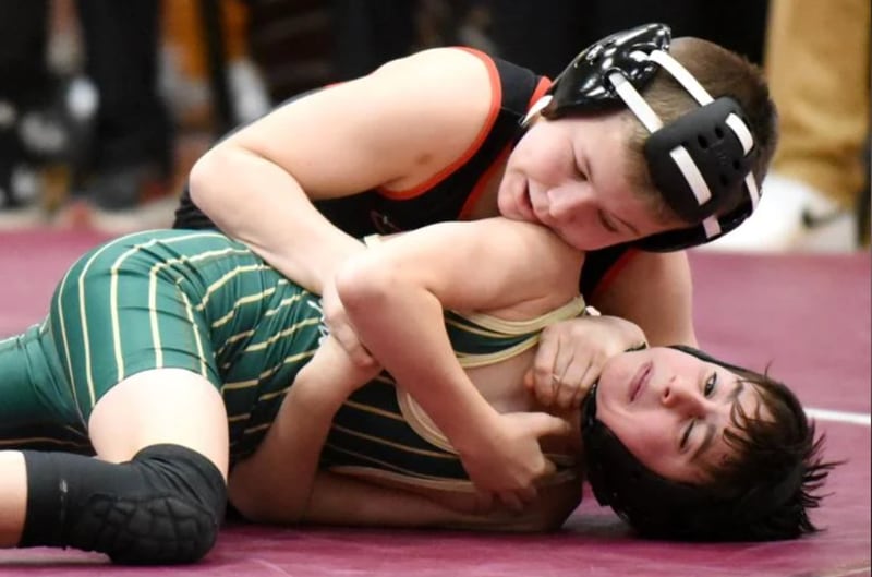 Bradley-Bourbonnais' Evan Johnson, top, gets position on Bishop McNamara's Parker Provost during Wednesday's All-City meet.