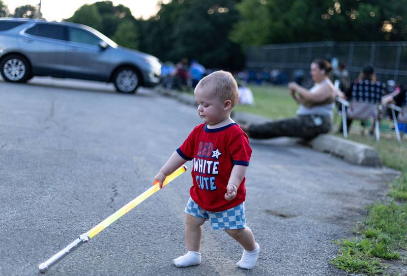 Cooper Culjan, 1, plays with a light-up toy before the “July 4th Fireworks” at Langum Park in St. Charles on Friday, July 4, 2025.