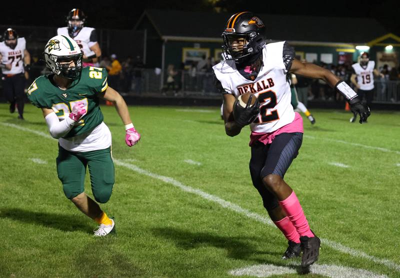 DeKalb's Derrion Straughter tries to get outside of Waubonsie Valley’s Nate Cerilli during their game Friday, Oct. 11, 2024, at Waubonsie Valley High School in Aurora.
