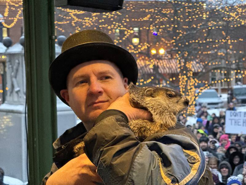 Woodstock Willie looks over the crowd on Woodstock Square on Feb. 2, 2026, after making his weather prediction. He's held by handler Mark Szafran.