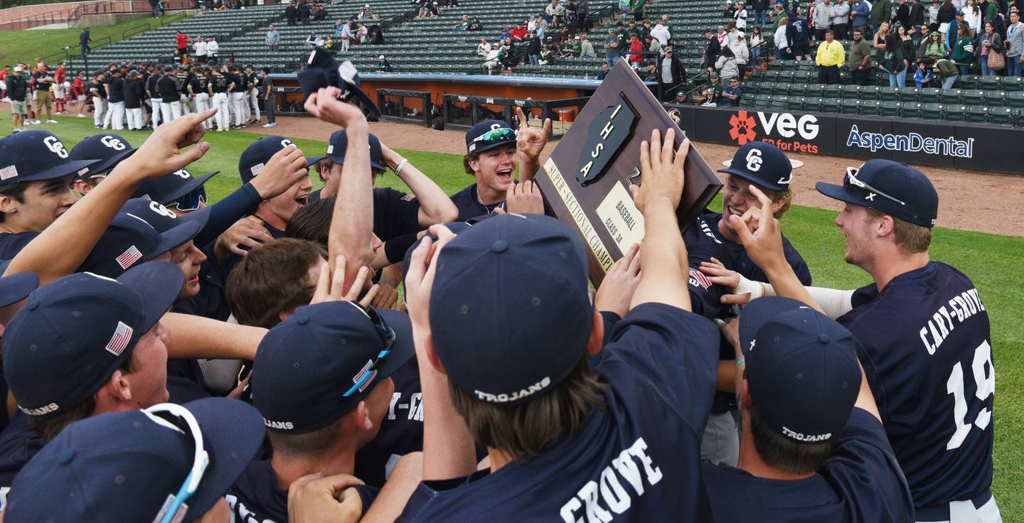 Cary-Grove players celebrate with their plaque after defeating St. Patrick 9-2 during the Class 3A supersectional baseball game at Wintrust Field on Monday, June 9, 2025 in Schaumburg.