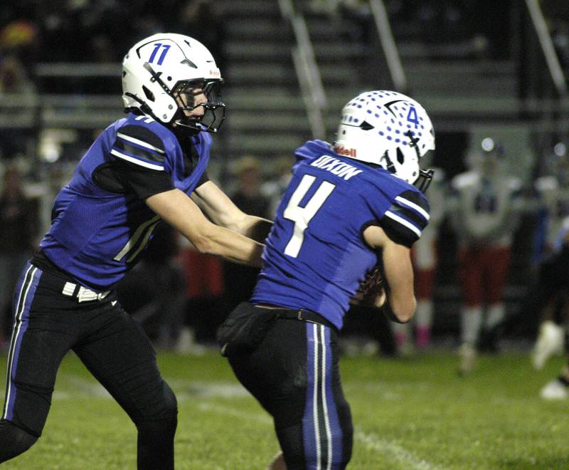 Dixon QB  Jagger Kemp hans off to Landon Knige. Genoa-Kingston traveled to Dixon to take on the Dukes. The game took place on Dixon's Senior Night, October 24th, 2025