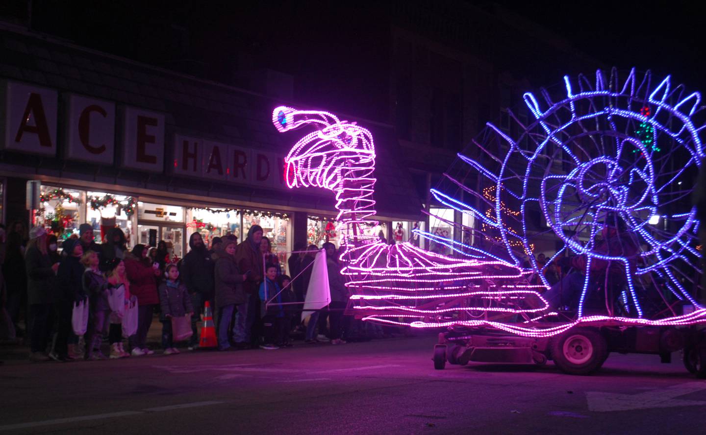 A lighted snail spins and performs weaving maneuvers to entertain the crowd during the Keeping Christmas Close to Home lighted parade Saturday, Nov. 26, 2022 in downtown Streator.
