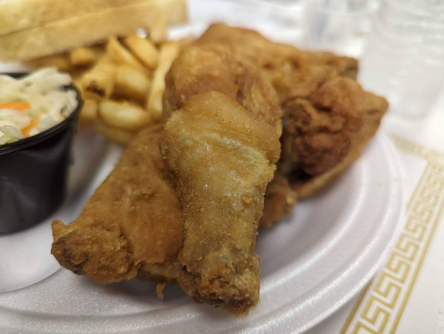 Pictured are the dark meat portions of a half chicken dinner as served at the Knights of Columbus Holy Trinity Council No. 4400 on Joliet's East side. The dinner also came with battered fries, vinegar cole slaw and two slices of bread.