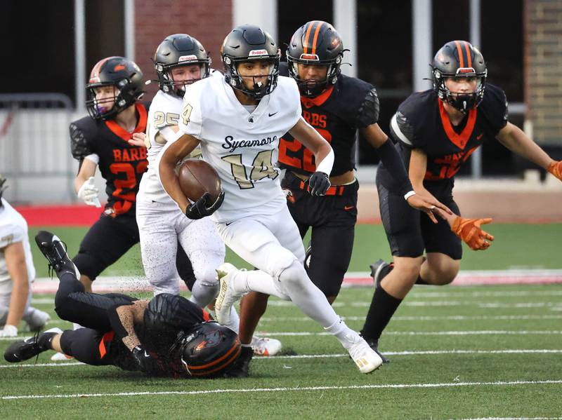 Sycamore's Josiah Mitchell leaves DeKalb defenders behind as he returns the opening kickoff for a touchdown Friday, Aug. 30, 2024, during the FNBO Challenge at Huskie Stadium at Northern Illinois University.