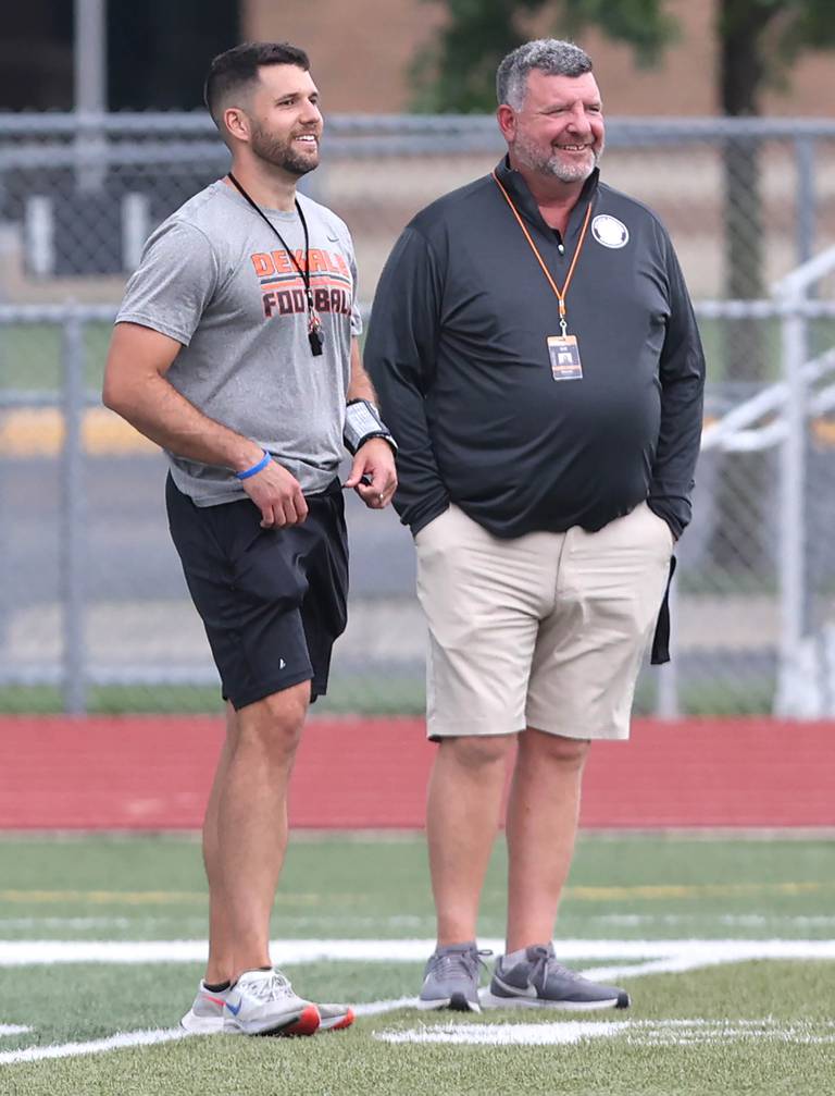 DeKalb football head coach Derek Schneeman (left) talks to athletic director Peter Goff during practice Wednesday, July 12, 2023, at the school.