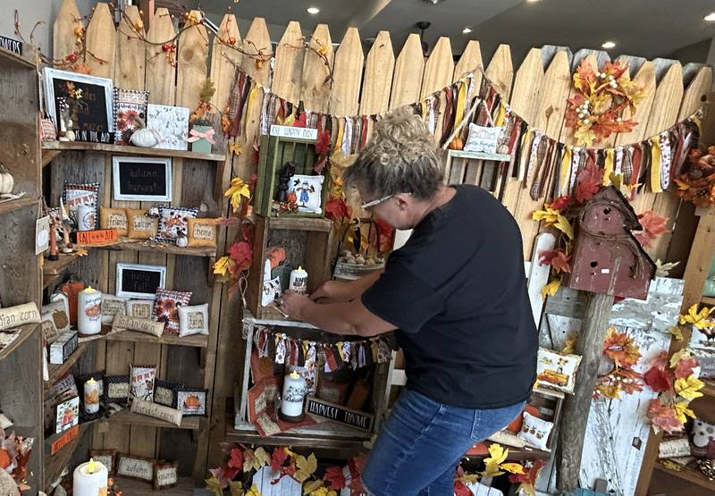 Sherri Badertscher, owner of First & Main, 101 E. Main St., Forreston, rearranges some of the items for sale in her store Saturday, Sept. 27, 2025, during the sixth annual Back Roads Market.