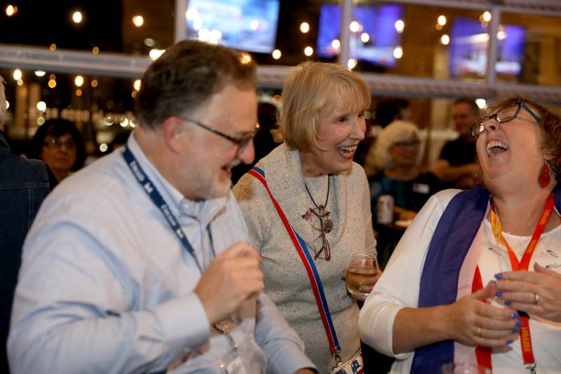 Kane County Board Chairman Corinne Pierog (center), running for reelection against challenger Lance Bell, talks with supporters Randall Lawrence (left) and Liisa Lawrence (right) of St. Charles while awaiting election results on Tuesday, Nov. 5, 2024 at Global Brew Tap House in St. Charles.