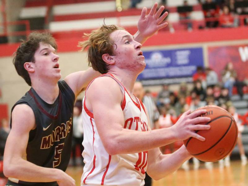 Ottawa's Evan Snook cuts in front of Morris's Charlie Wfright to dribble in the lane on Wednesday, Jan. 3, 2024 at Kingman Gym.