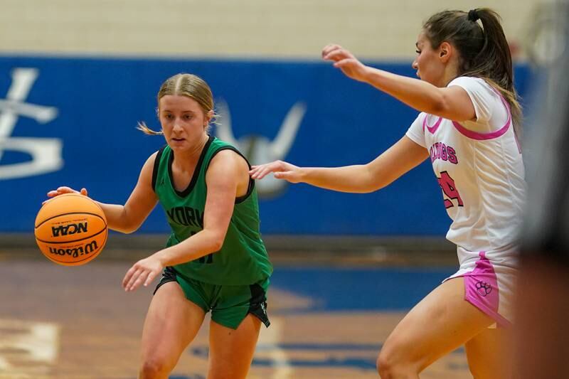 York's Briley O'Brien (11) drives to the basket against Batavia’s Hallie Crane (24) during a Class 4A Geneva Regional final basketball game at Geneva High School on Thursday, Feb. 20, 2025.