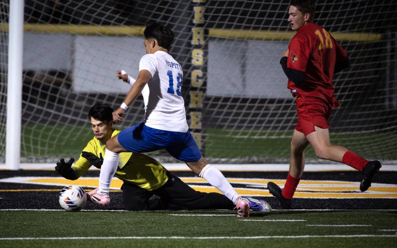 St. Anne's David Rappo dives to make a save as Clifton Central's Erick Gutierrez dribbles the ball into the box in a regional match-up on Tuesday, October 21, 2025.