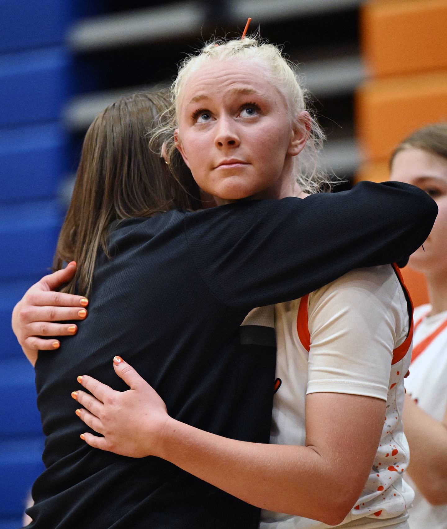St. Charles East’s Addie Schilb hugs coach Katie Claussner after coming out of the game with less than a minute left in the game during the Saint’s 56-34 loss to Loyola Academy in the Class 4A girls basketball supersectional at Hoffman Estates High School on Monday, March 2, 2026.