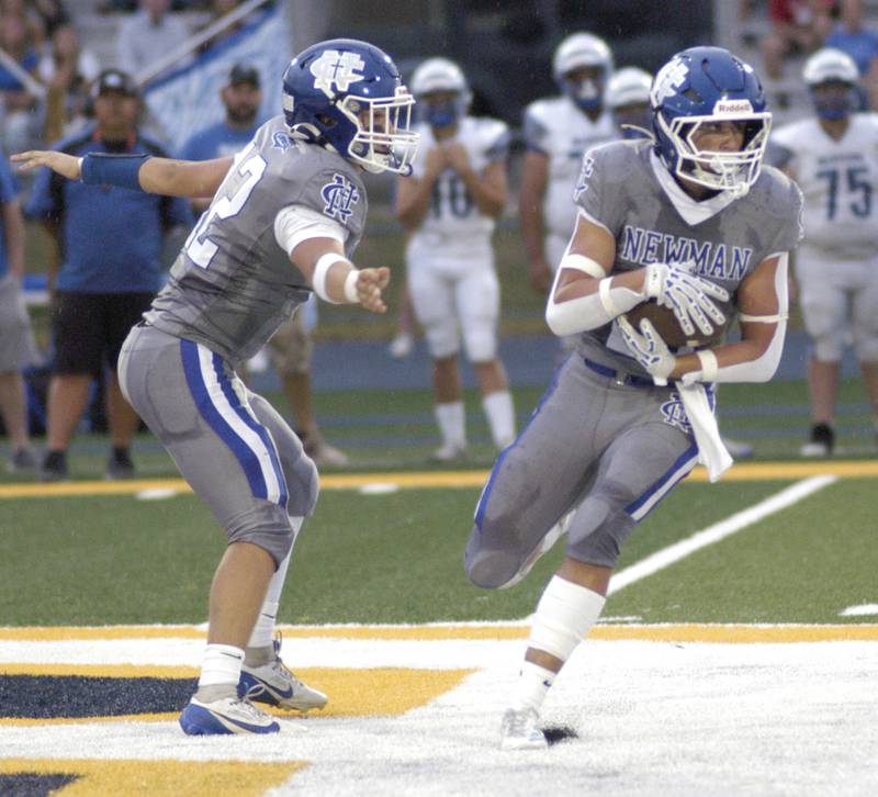 Newman QB Evan Bushman hands to  Rylan Alvarado. Newman Central Catholic H.S hosted Princeton H.S. in a non-conference football game at Sterling H.S, on Friday, August 29, 2025.