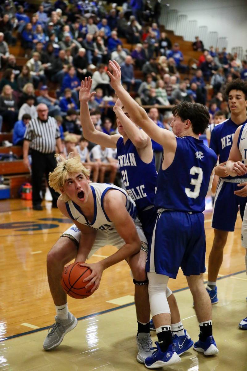 Princeton's Noah LaPorte eyes the bucket guarded Newman's Cody McBride and Garrett Matznick (3) Tuesday at Prouty Gym. He scored 29 points to lead the Tigers to a 59-54 win.