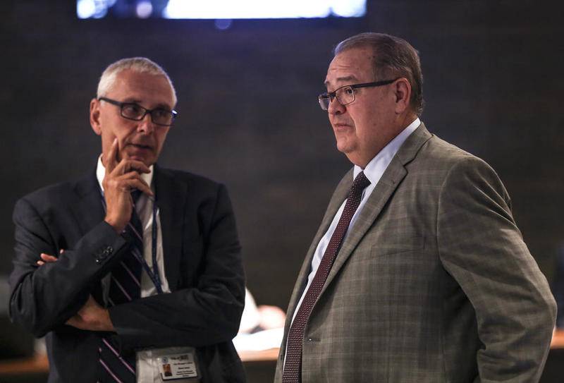 David Hales, the city manager for Bloomington, (right) speaks to Steve Jones, deputy city manager, on Sept. 19 in Joliet.