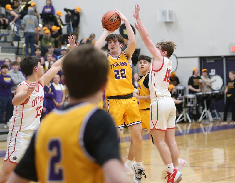 Mendota's Aden Tillman shoots a jump shot between Ottawa's Cooper Knoll and Evan Snook on Tuesday, Feb. 13, 2024 at Mendota High School.