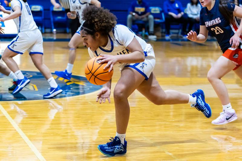 Joliet Central's Melani Tua-Link goes on the offensive during a varsity girls basketball game against Romeoville at Joliet Central on Dec. 18, 2025.