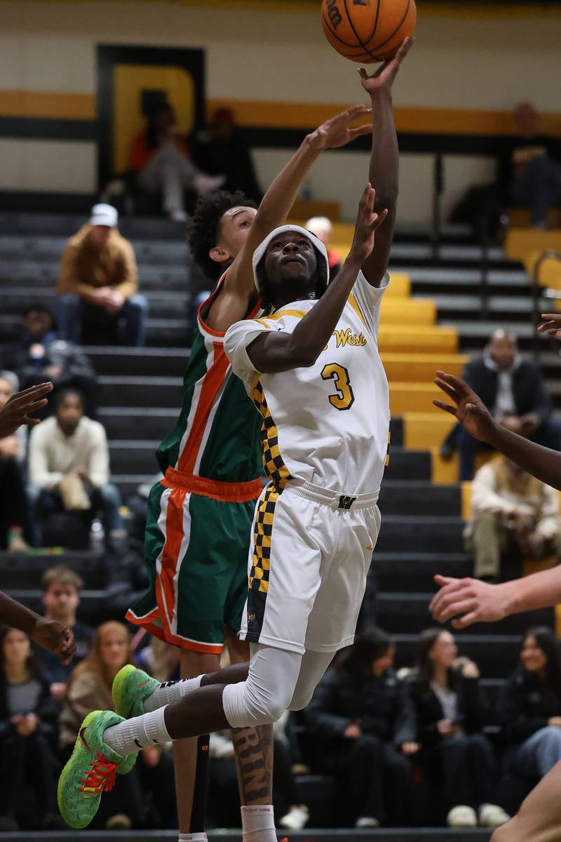 Joliet West’s Deven Triplett finesse a shot against Plainfield East on Friday, Dec. 19, 2025 in Joliet.