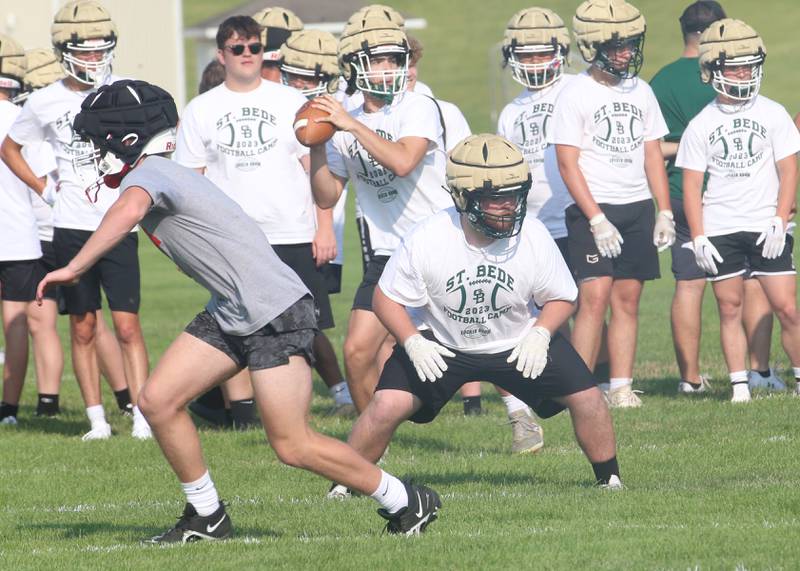 St. Bede quarterback Max Bray throws a pass as center Mateo Pullara blocks during a 7-on-7 meet against Ottawa on Monday, July 17, 2023 at Ottawa High School.