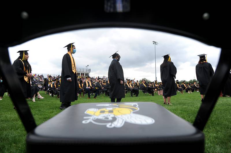 Graduating seniors wait to receive their diplomas Sunday afternoon, May 23, 2021, during the commencement ceremony at Harvard High School’s Dan Horne Field in Harvard. More than 170 students took part in the school’s graduation ceremony.