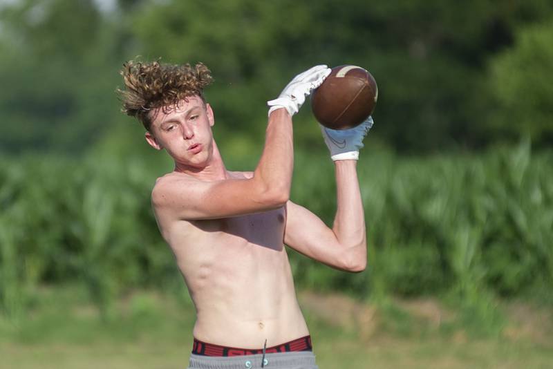 Ryelan Lindaas hauls in a pass during football drills in Polo Thursday, July 7, 2022.