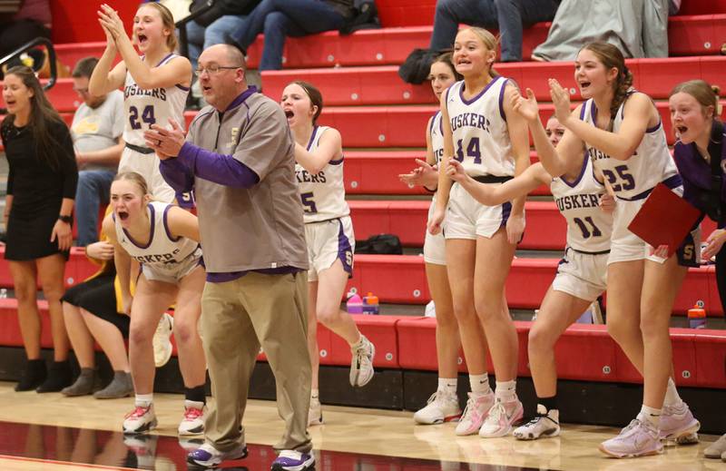 Serena head basketball coach Jom Jobst reacts with members of the Lady Huskers after winning the Little Ten Conference championship over Hinckley-Big Rock on Friday, Jan. 24, 2025 at Earlville High School.