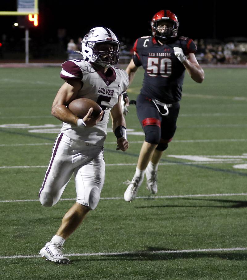 Prairie Ridge's Luke Vanderwiel runs away from Huntley's Bejaminn Cohen during a Fox Valley Conference football game on Friday, Sept. 20, 2024, at Huntley High School.
