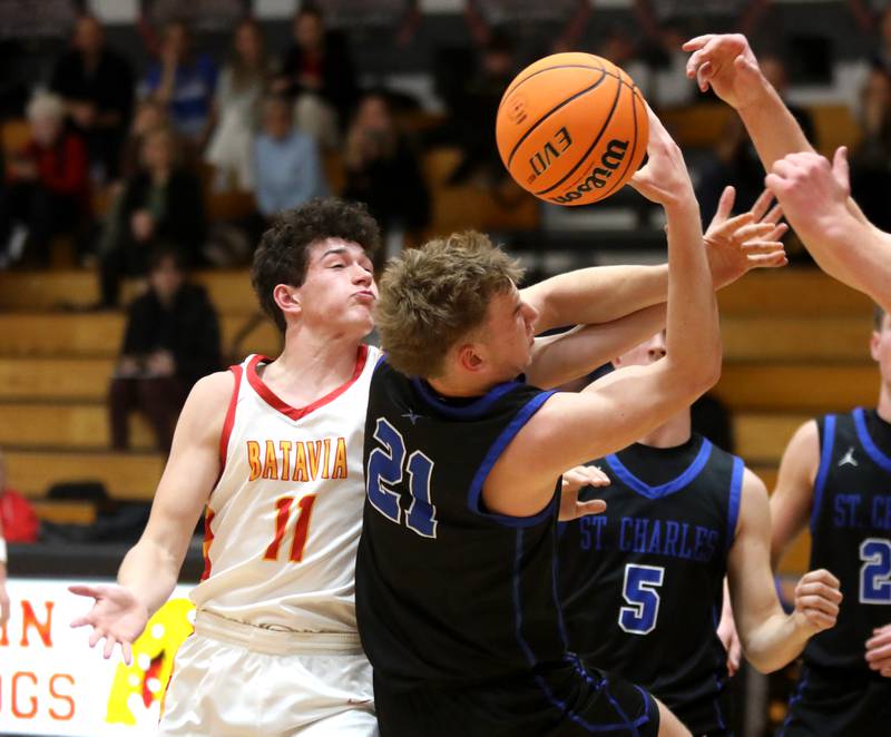 Batavia’s Josh Kahley and St. Charles North’s Camden Vine go after a rebound during a game on Wednesday, Dec. 11, 2024 in Batavia.