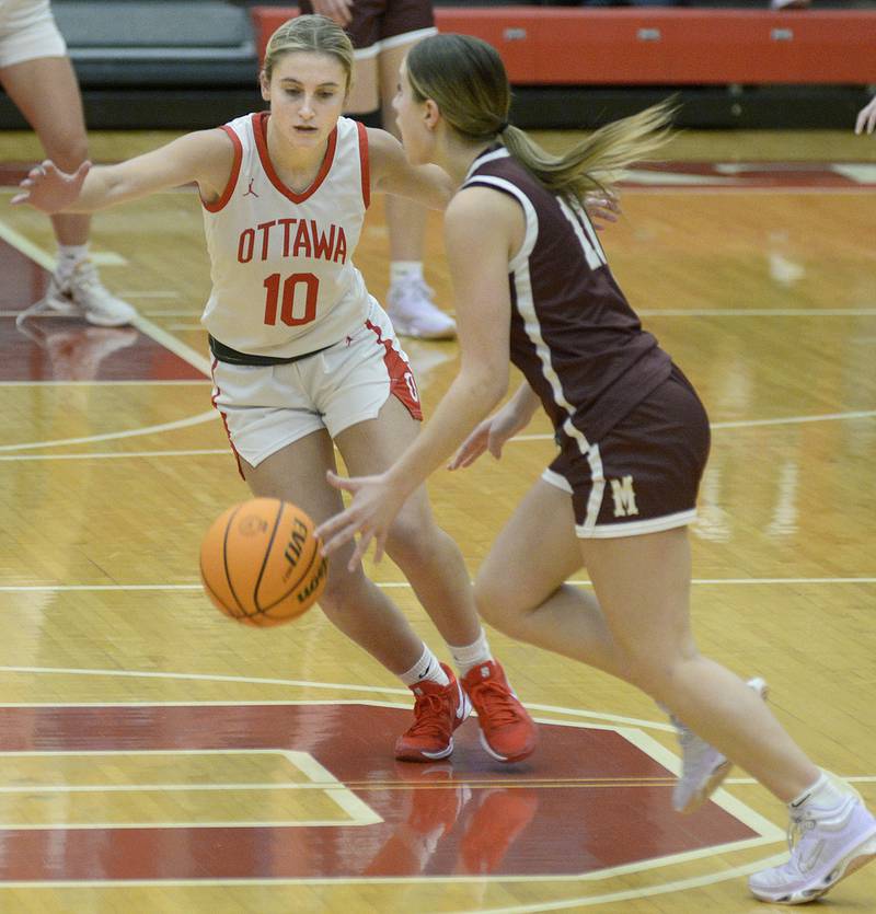 Morris’s Alyssa Jepson tries to drive past Ottawa’s Ells Schmitz in the 2nd period Saturday during the Ottawa Holiday Tournament.