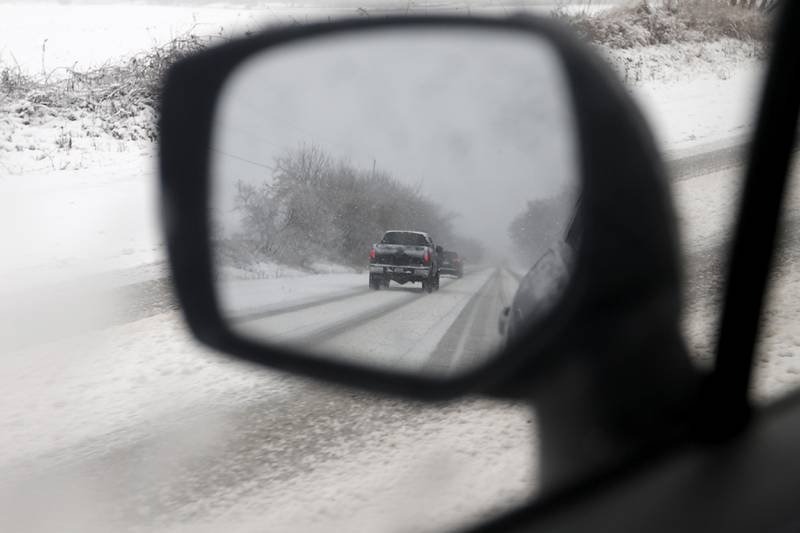 Motorists travel on snow covered Illinois 173 near Richmond as a winter storm moves through McHenry County on Tuesday, Jan. 9, 2024, delivering snow to most of the county.