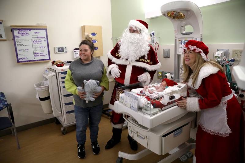 Teresa Rocha of Glendale Heights and her son, Damian, get a visit from Santa and Mrs. Claus in the NICU at Northwestern Medicine Central DuPage Hospital in Winfield on Wednesday, Dec. 20, 2023.