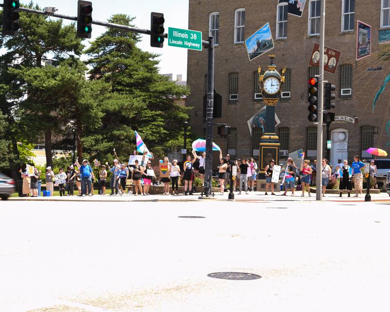 Dozens line the corner at Lincoln Highway and First Street during a Trans Resilience Rally held on Sunday, June 22, 2025, in downtown DeKalb. Organizers said the rally was to show public support for people they believe are unjustly and harmfully targeted under President Donald Trump's policies.