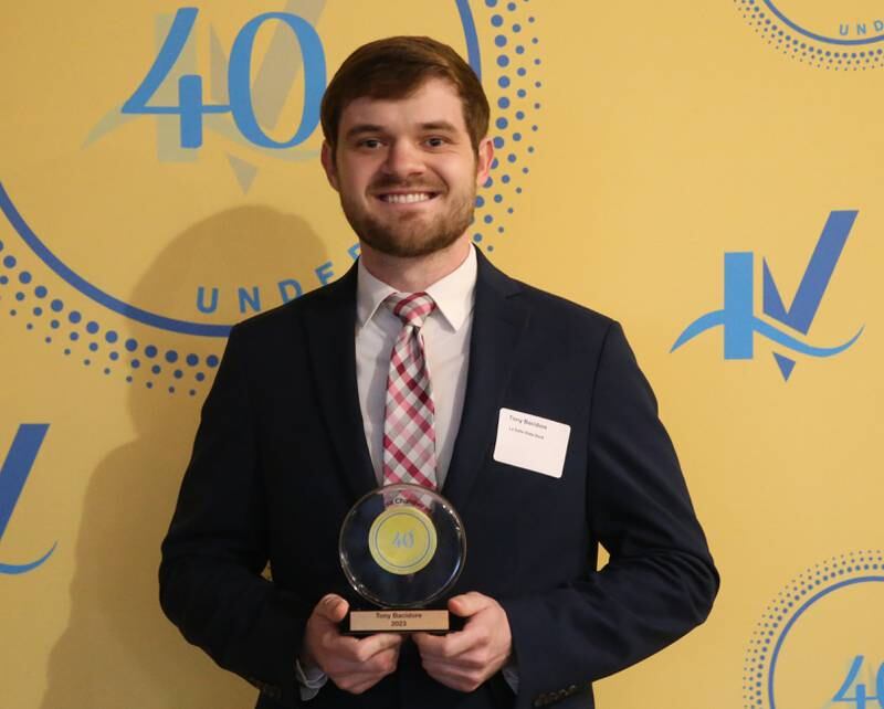 Tony Bacidore poses for a photo with his award during the 40 Under Forty awards banquet on Thursday, March 21, 2024 at Westclox in Peru.