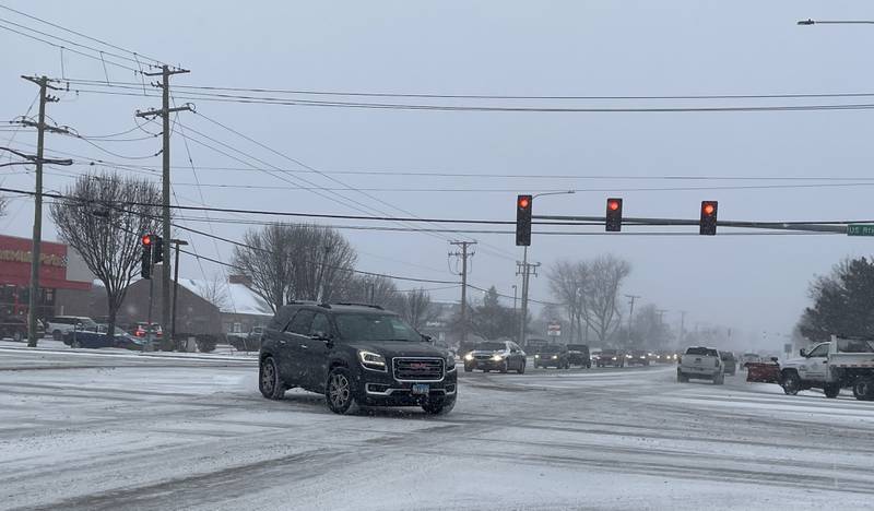 Traffic moves slowly through the Route 30 and Douglas Road intersection in Oswego early Thursday afternoon, Dec. 22, 2022, amid the first winter storm of the season.